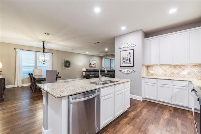 kitchen with sink, decorative light fixtures, stainless steel dishwasher, white cabinets, and an island with sink