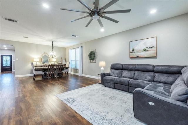 living room featuring dark hardwood / wood-style flooring, plenty of natural light, and ceiling fan