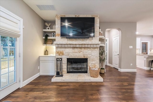 unfurnished living room with dark hardwood / wood-style flooring and a fireplace