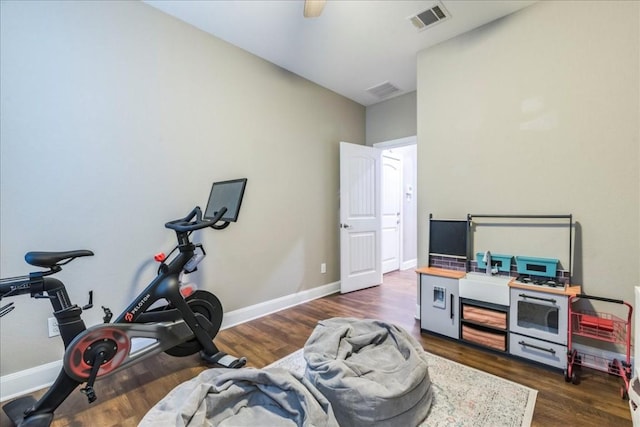 exercise room with dark hardwood / wood-style flooring