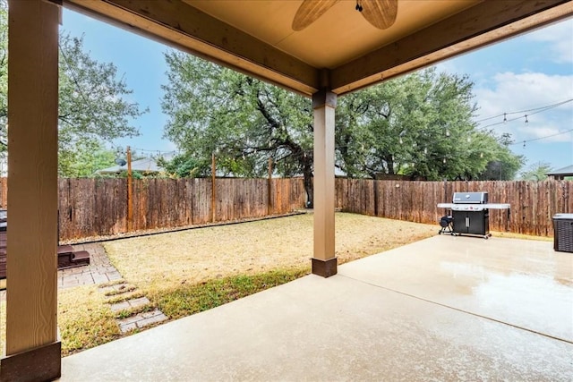 view of patio featuring ceiling fan and a grill