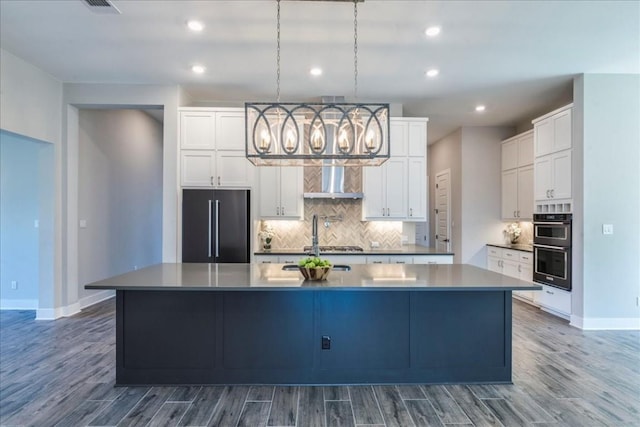 kitchen featuring a spacious island, dark wood-type flooring, white cabinetry, pendant lighting, and high end fridge