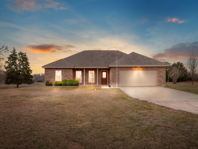 prairie-style home with a garage and a yard