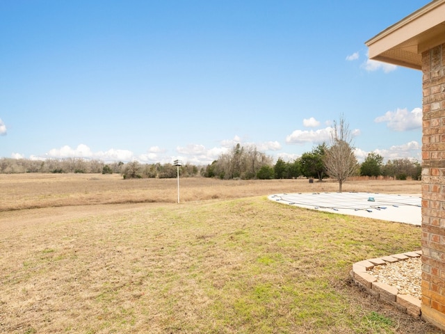 view of yard with a rural view