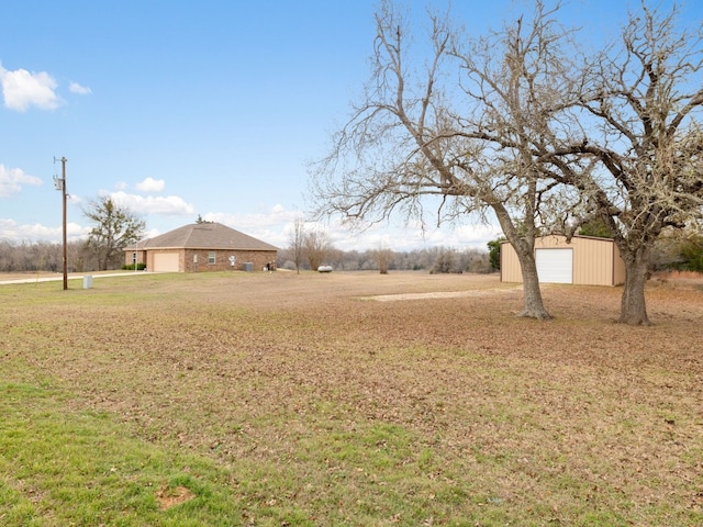 1504 County Road 459, Thorndale, TX 76577 - view of green lawn featuring a detached garage and an outbuilding