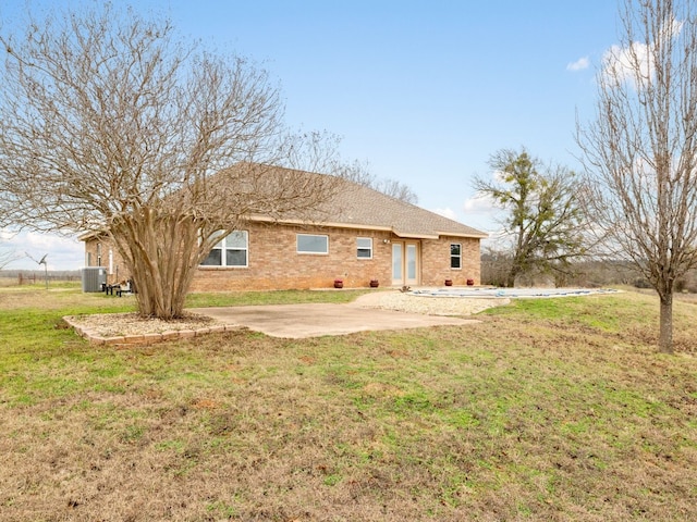 back of house featuring central AC unit, a yard, a patio area, and french doors