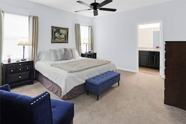 carpeted bedroom with connected bathroom and ceiling fan