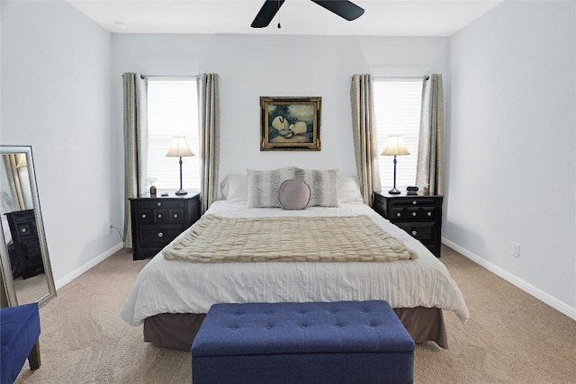 carpeted bedroom featuring ceiling fan and multiple windows