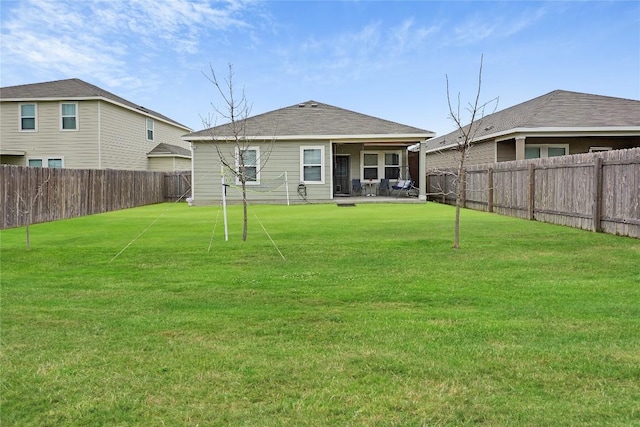 rear view of house featuring a lawn