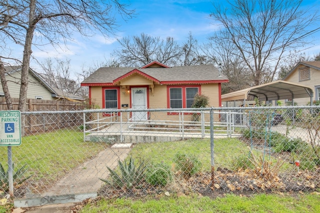 view of front facade with a front yard and a carport