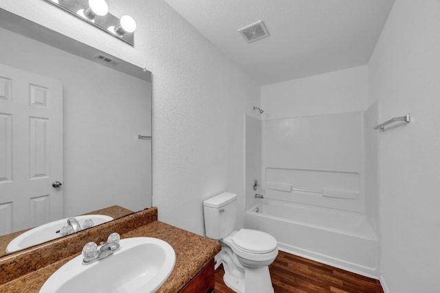 full bathroom with vanity, shower / bathing tub combination, hardwood / wood-style floors, and toilet