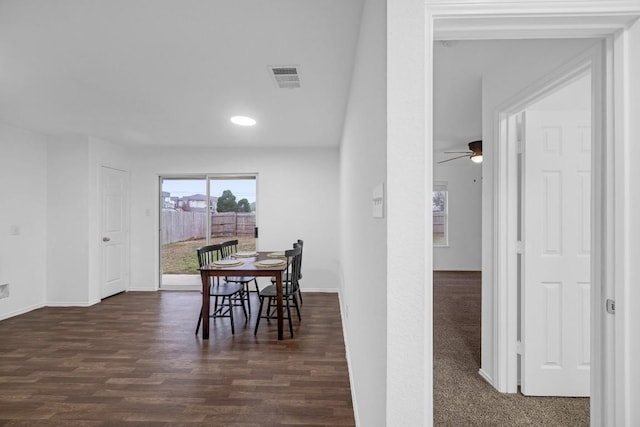 dining space featuring dark wood-type flooring and ceiling fan