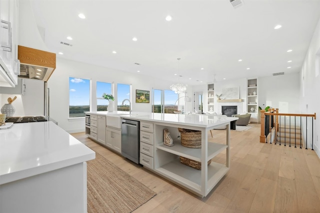 kitchen featuring white cabinetry, a large island, and light hardwood / wood-style floors