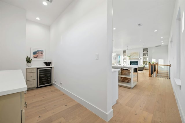 corridor featuring wine cooler and light hardwood / wood-style flooring