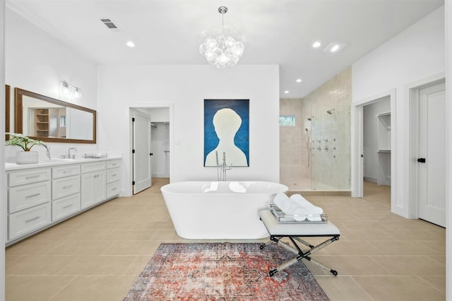 bathroom with vanity, tile patterned floors, shower with separate bathtub, and an inviting chandelier