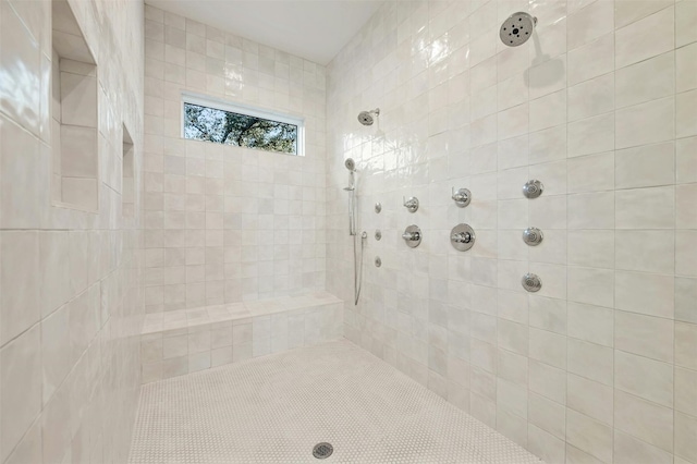 bathroom with tiled shower