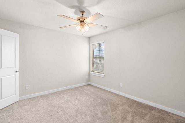 carpeted empty room featuring ceiling fan