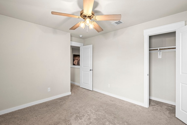 unfurnished bedroom with light colored carpet, ceiling fan, and a closet