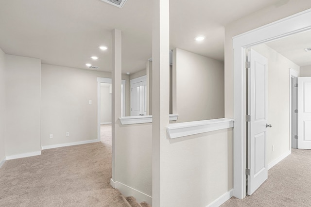 hallway with light colored carpet