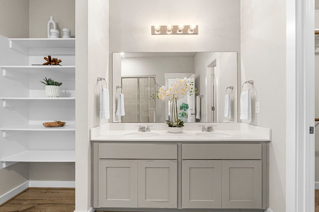 bathroom with vanity, hardwood / wood-style flooring, and a shower with shower door