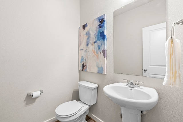 bathroom featuring toilet and sink