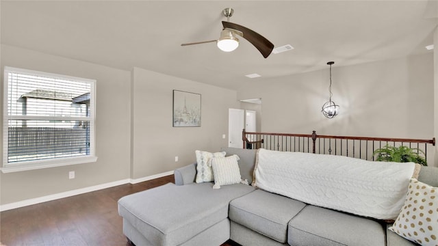 living room featuring ceiling fan and dark hardwood / wood-style flooring