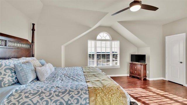 bedroom with a ceiling fan, vaulted ceiling, dark wood finished floors, and baseboards