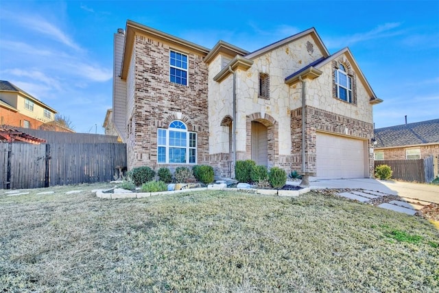 view of front of property featuring a garage, concrete driveway, stone siding, fence, and a front yard