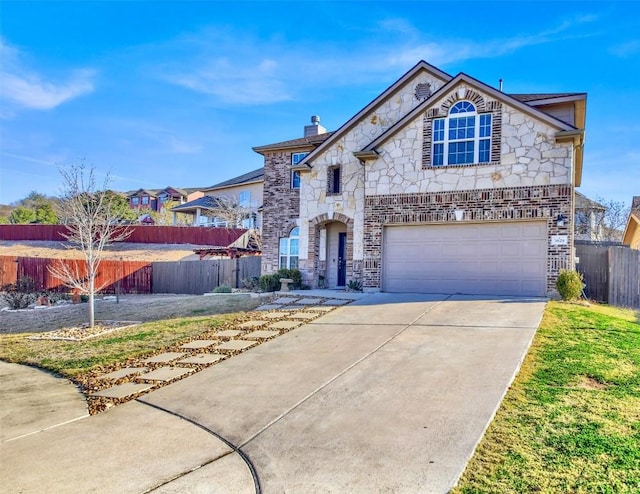 french provincial home featuring a garage, concrete driveway, stone siding, fence, and brick siding