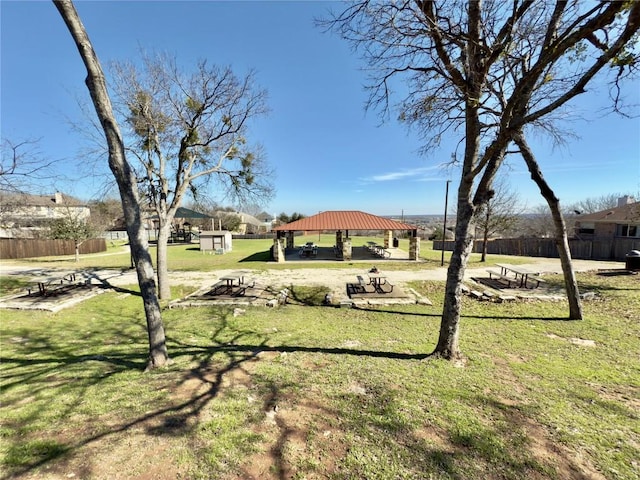 view of property's community featuring a yard, fence, and a gazebo