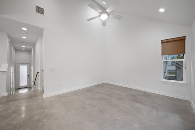 spare room featuring concrete flooring, high vaulted ceiling, and ceiling fan