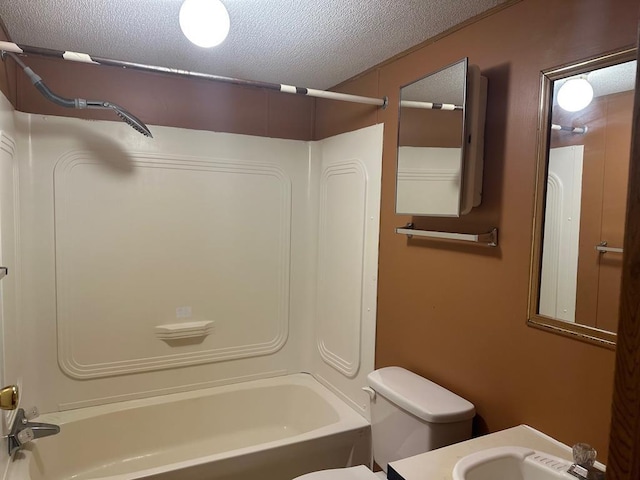 full bathroom featuring shower / tub combination, vanity, a textured ceiling, and toilet