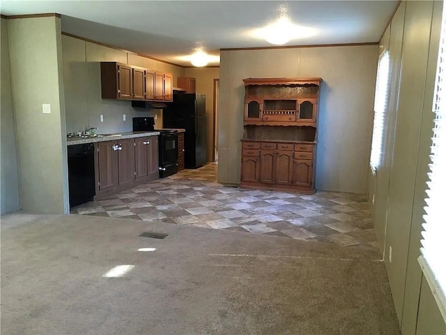 kitchen featuring ornamental molding, sink, light carpet, and black appliances