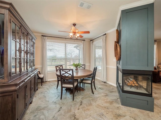 112 Chaumont St, Kingsland, TX 78639 - dining room featuring a ceiling fan, stone finish floor, crown molding, visible vents, and baseboards