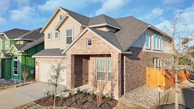 view of front of home with brick siding, a shingled roof, concrete driveway, fence, and a garage