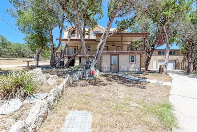 view of front facade featuring a garage and a balcony