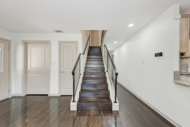 stairway featuring wood-type flooring