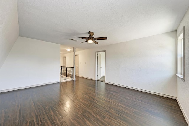 unfurnished living room with ceiling fan, dark hardwood / wood-style floors, and a textured ceiling