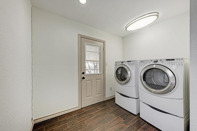 clothes washing area with washing machine and dryer