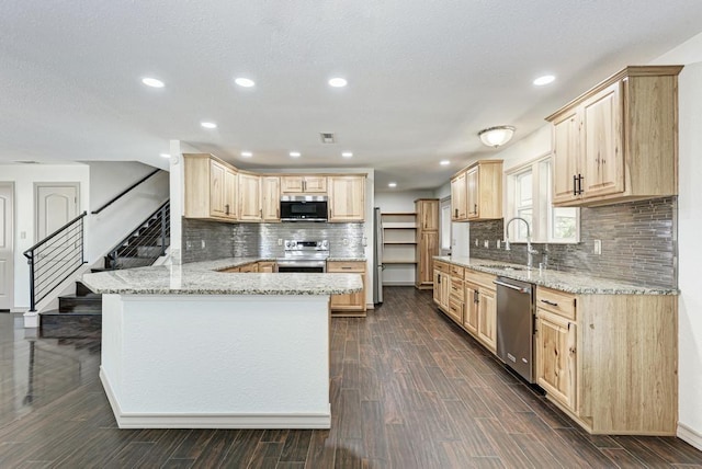 kitchen with appliances with stainless steel finishes, sink, kitchen peninsula, dark wood-type flooring, and light brown cabinets