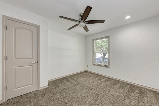 spare room with carpet floors and ceiling fan