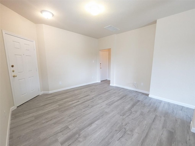 unfurnished room featuring light hardwood / wood-style floors