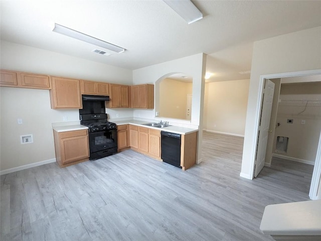 kitchen featuring sink, light wood-type flooring, and black appliances