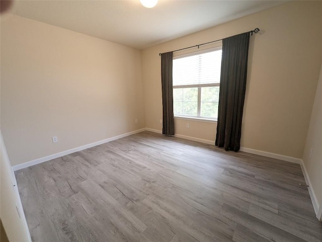 unfurnished room with light hardwood / wood-style flooring