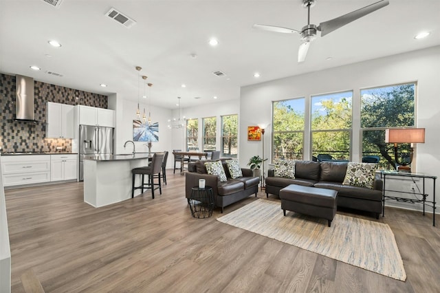 living area featuring wood finished floors, visible vents, and recessed lighting