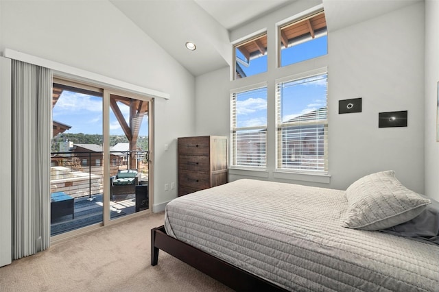 carpeted bedroom with high vaulted ceiling and access to exterior