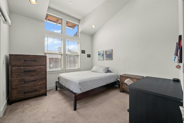 bedroom featuring lofted ceiling, light carpet, and recessed lighting
