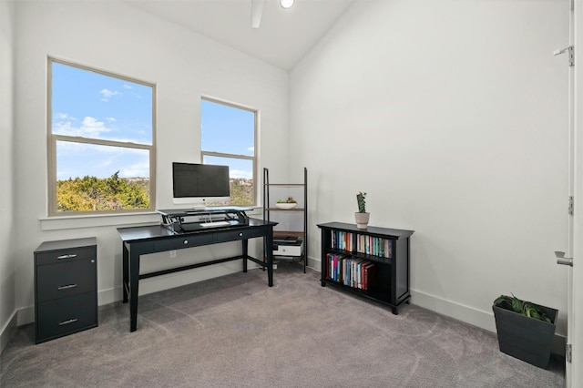 office space with lofted ceiling, baseboards, and carpet