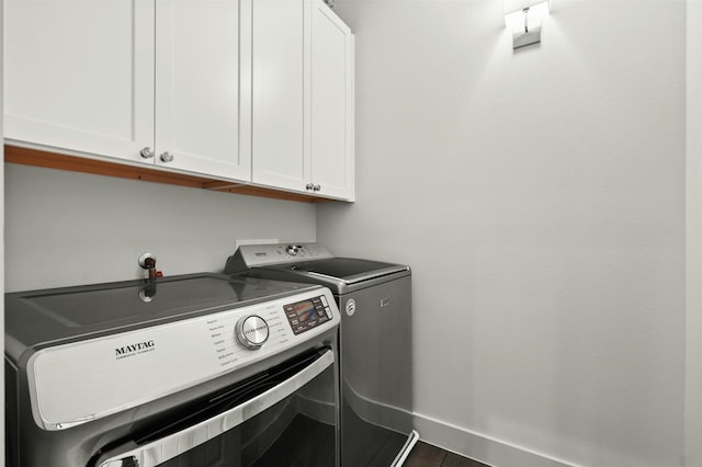 laundry room with cabinet space and washer and clothes dryer