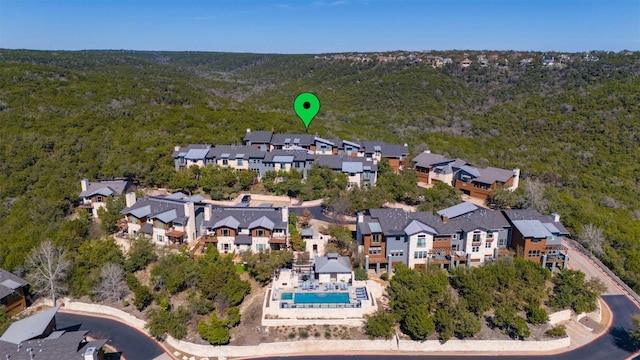 birds eye view of property featuring a residential view and a view of trees